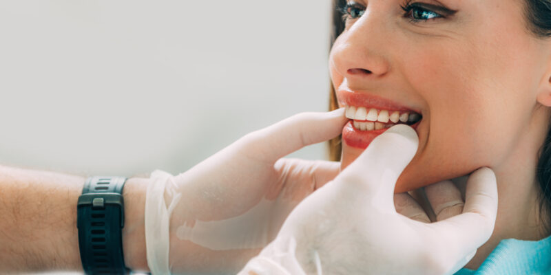 Young smiling woman with beautifiul teeth, having a dental inspection