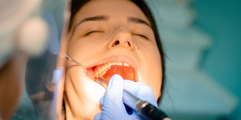 young woman having a tooth extracted