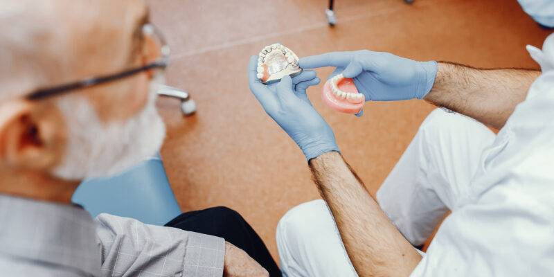 dentist showing a denture option to a patient