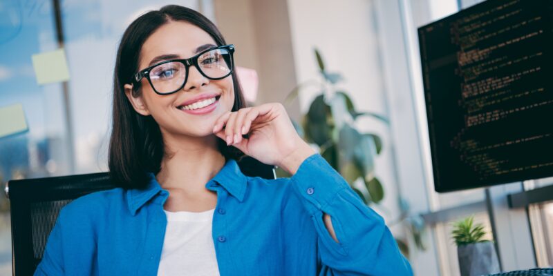professional woman smiling at her desk, perfect white teeth