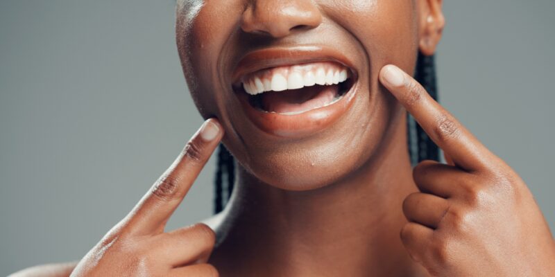 closeup, cropped woman showing healthy teeth and gums